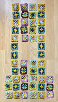 crocheted squares laid out on the floor to be used as coasters or wall hangings