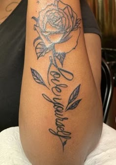 a woman with a rose tattoo on her arm