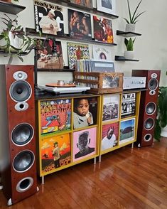 an entertainment center with speakers and pictures on the wall