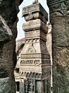 an intricately carved stone structure in the middle of some rocks