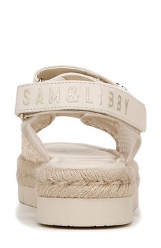 Gleaming hardware adorns the straps of an adjustable woven sandal fitted with a cushioned footbed for comfort and style. 1 3/4" heel Synthetic and textile upper/synthetic lining and sole Imported Cream Synthetic Sandals With Woven Sole, Cream Sandals With Adjustable Strap For Summer, Flat Sport Sandals With Adjustable Strap, Beige Sandals With Adjustable Strap, White Synthetic Sport Sandals With Adjustable Straps, Adjustable Cream Synthetic Sandals, Adjustable Beige Sandals With Strap, Beige Adjustable Strap Sandals, Adjustable Beige Sport Sandals With Cushioned Footbed