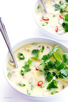 two bowls filled with soup and garnished with cilantro