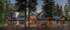 a large house surrounded by trees in the woods