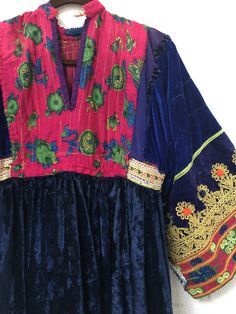 "A gorgeous, traditional Afghani Kutchi dress made by hand. Me asurements are 20\" across the chest. 48\" from mid shoulder to the bottom of the piece. 19 1/2\" long from shoulder to wrist." Folk Style Embroidered Transitional Dresses, Traditional Dress With Embroidered Neckline For Festivals, Folk Style Ceremonial Dress With Embroidered Border, Ceremonial Folk Dress With Embroidered Border, Bohemian Ceremonial Dress With Floral Embroidery, Ceremonial Bohemian Dress With Floral Embroidery, Bohemian Floral Embroidered Dress For Transitional Seasons, Ceremonial Folk Style Embroidered Dresses, Ceremonial Bohemian Embroidered Fitted Dress