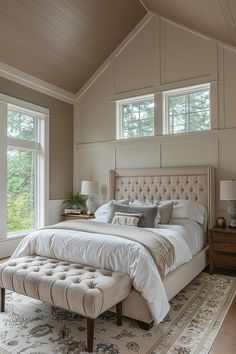 a bedroom with a large bed and lots of windows in it's ceiling area