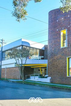 the building is made of brick and has yellow trim