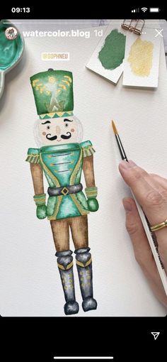 a drawing of a nutcracker in green and gold with watercolor on paper