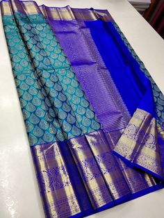 blue and gold banaram saree with matching palli on the bottom half