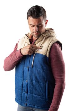 The Colt Vest is Gobi Heat’s most feature-rich vest yet (and perhaps our trendiest too). Bringing you all the features you love about our stylish outerwear, the Colt Vest is here so you can look and feel your best. Featuring a drawstring hood, this vest allows you to customize your style with ease. Kick back the clock in this thick puffer vest with a timeless two-toned design. The microsuede outer shell is available in a deep blue and cream combination named Shoreline. The Colt Vest will keep yo Fall Outdoor Vest Outerwear, Cotton Vest Outerwear For Cold Weather, Urban Cotton Vest For Fall, Urban Vest For Outdoor Activities, Cotton Vest Outerwear For Outdoor, Cotton Vest For Outdoor Wear, Conductive Thread, Trendy Vest, Heated Vest