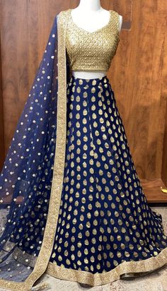 Blue georgette skirt with gold embroidered blouse! Blouse and lehenga stitching is included! Blouse style is same for entire order. Blouses are stitched to individual measurements but the shape of the neckline needs to be the same. For example- If you choose a sweetheart neckline all bridesmaids will have a sweetheart neckline but one bridesmaids can have the depth to be 8inches vs. the other can ask the neckline to be 10inches. Final fittings/alterations not included. Fabric - Georgette, Net Br Blue Golden Lehenga, Gold Unstitched Party Wear Lehenga, Gold Georgette Lehenga For Party Wear, Gold Unstitched Lehenga For Party Wear, Gold Cutdana Traditional Party Wear, Georgette Long Skirt Sets With Zari Work, Festive Long Skirt Dupatta In Georgette, Gold Georgette Lehenga For Reception, Festive Long Georgette Dupatta