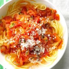 a white bowl filled with pasta covered in marinara sauce and parmesan cheese