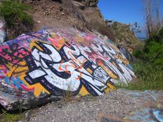 graffiti on the side of a large rock