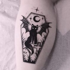 a tattoo on the leg of a woman with a bat and moon above it, in black and white