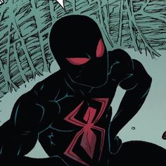 the spider - man is sitting in front of some trees and has his hands on his knees