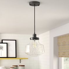 a light fixture hanging from the ceiling in a kitchen