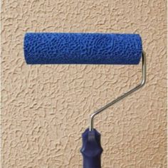 a blue paint roller on the side of a wall