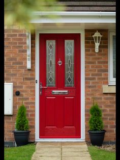 a red front door on a brick house