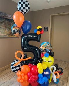 a birthday cake made out of balloons with the number five on it