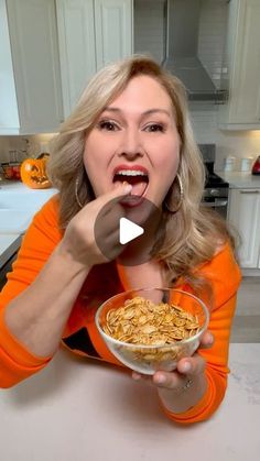 a woman eating cereal out of a bowl