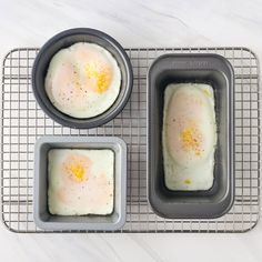 three eggs in pans on a cooling rack