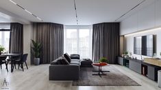 a living room filled with furniture and a flat screen tv on top of a wooden floor