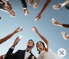 a group of people holding wine glasses in the air