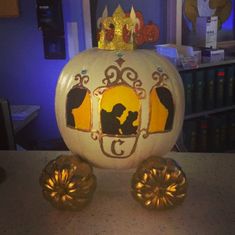 a white pumpkin with a golden crown on it's head sitting on top of a table