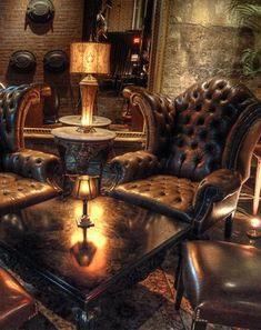 a living room filled with lots of leather furniture