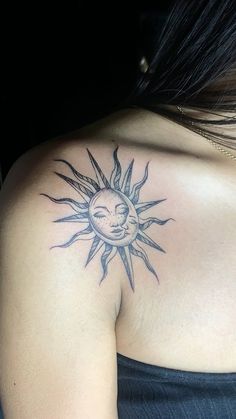 a woman with a sun and moon tattoo on her shoulder