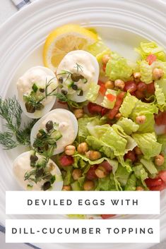 deviled eggs with dill - cucumber toppings on a white plate