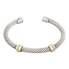 Authentic and elegant by David Yurman, this fine cable cuff bracelet is crafted from sterling silver with 14k yellow gold accent.  The front of the 5mm thick cable band has two yellow gold fine beaded design motif.  It is signed by the designer with the gold and silver content.  Brand: David Yurman Hallmark: D.Y 925 585 Material:  14k yellow gold and sterling silver   Measurement:  6.25' with opening x 5mm wide x 5mm Weight: 30.5 grams Gold Accent, Bead Designs, David Yurman, Gold Beads, Gold And Silver, Gold Accents, Cuff Bracelet, Hallmark, Cuff Bracelets