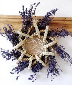 an arrangement of dried lavenders on a wooden shelf