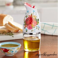 a tea pot with flowers on it next to some bread