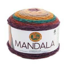 a multicolored ball of yarn sitting on top of a white surface with the word mandala written across it