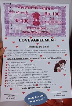 a person holding up a love agreement paper