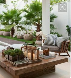 an outdoor living room with plants and candles