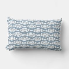 a blue and white pillow with wavy waves on it