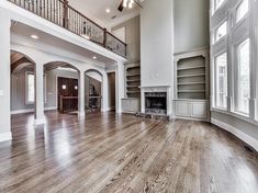 an empty living room with wood flooring and white trim on the walls is pictured in this image