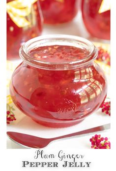 a glass jar filled with liquid sitting on top of a table next to spoons