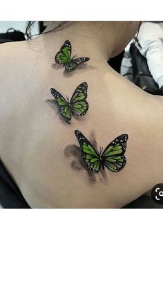 three green butterflies on the back of a woman's upper back neck and shoulder