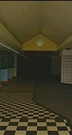 an empty room with black and white checkered floors