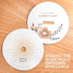 two round coasters with floral designs on them sitting on a table next to each other