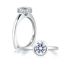 an engagement ring with a diamond on the side and a round stone in the middle