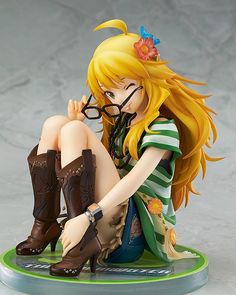 a figurine sitting on top of a green base