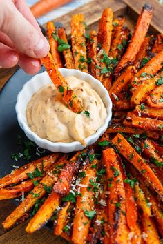 a plate with carrots and dipping sauce on it