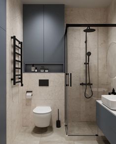 a bathroom with a toilet, sink and shower