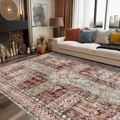 a living room filled with furniture and a large rug on top of a hard wood floor