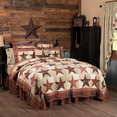 a bed with a brown and white quilt on it next to a wooden headboard