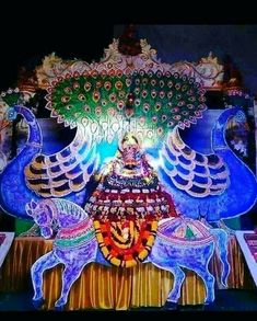 an elaborately decorated stage with elephants and peacocks