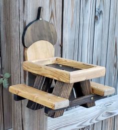 a wooden bench sitting next to a fence